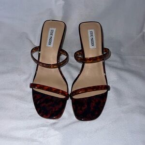 Steve Madden black heel slide sandal with tortoise straps, size 9.